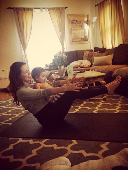 Grace and her daughter practicing Yoga.